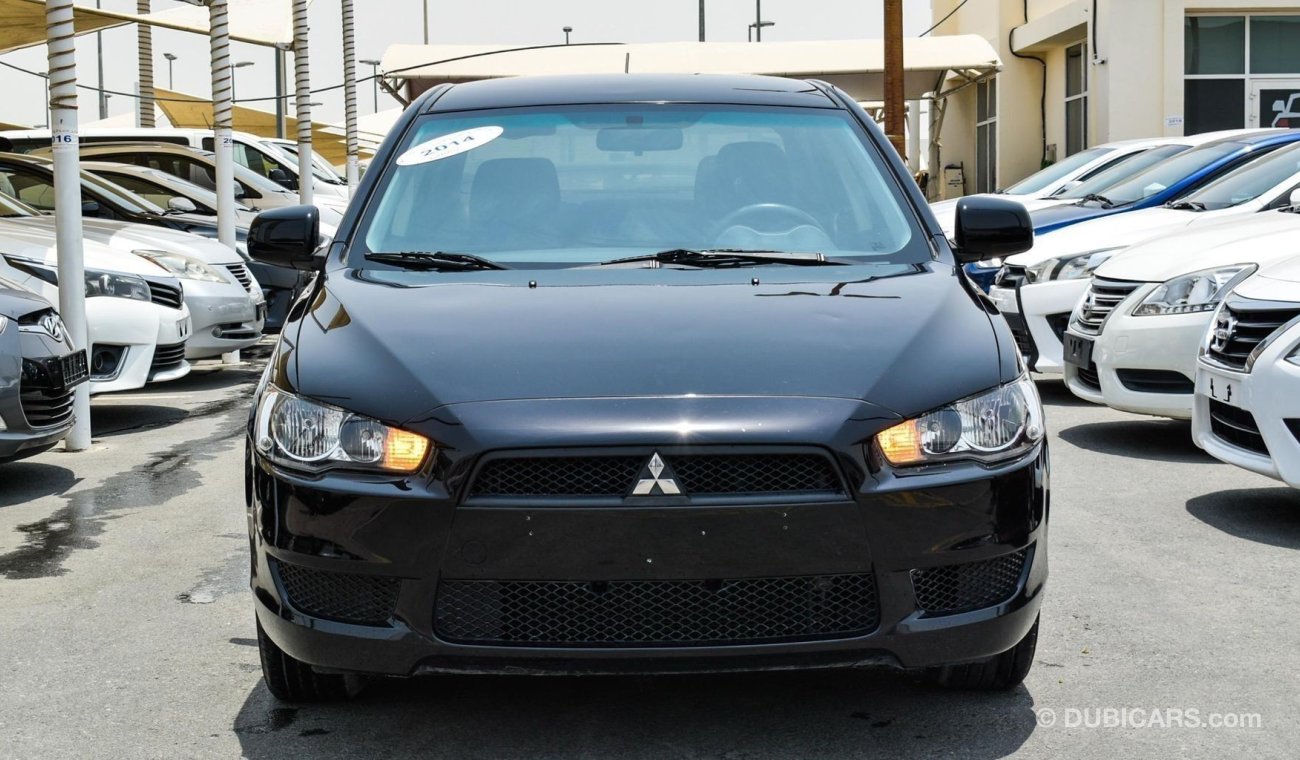 Mitsubishi Lancer ميتسوبيشي لانسر 2014حاله ممتازة بدون صبغ بدون حوادث حالة ممتازة داخل وخارج حالة الوكالة تحت الضمان