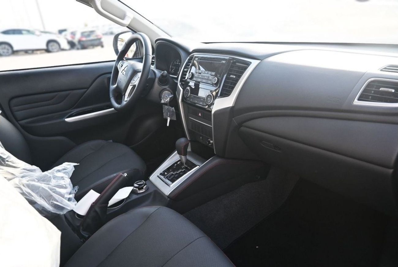 ميتسوبيشي L200 ميتسوبيشي L200 ديزل فل أوبتيون أوتوماتيك 2.4 لتر برتقالي من الخارج أسود من الداخل