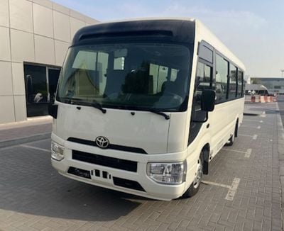 Toyota Coaster 4.0L ECTTAE004 - 2026 Toyota Coaster - 4.0L Diesel Manual – 23 Seats, Auto Door, 3PSB, Mic, Baggage Rack