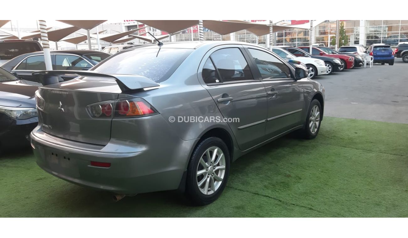 Mitsubishi Lancer Gulf gray color inside beige without accidents Rings rear wing sensors fog lights in excellent condi