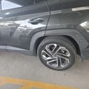 Hyundai Tucson PREMIUM PLUS An olive green car.