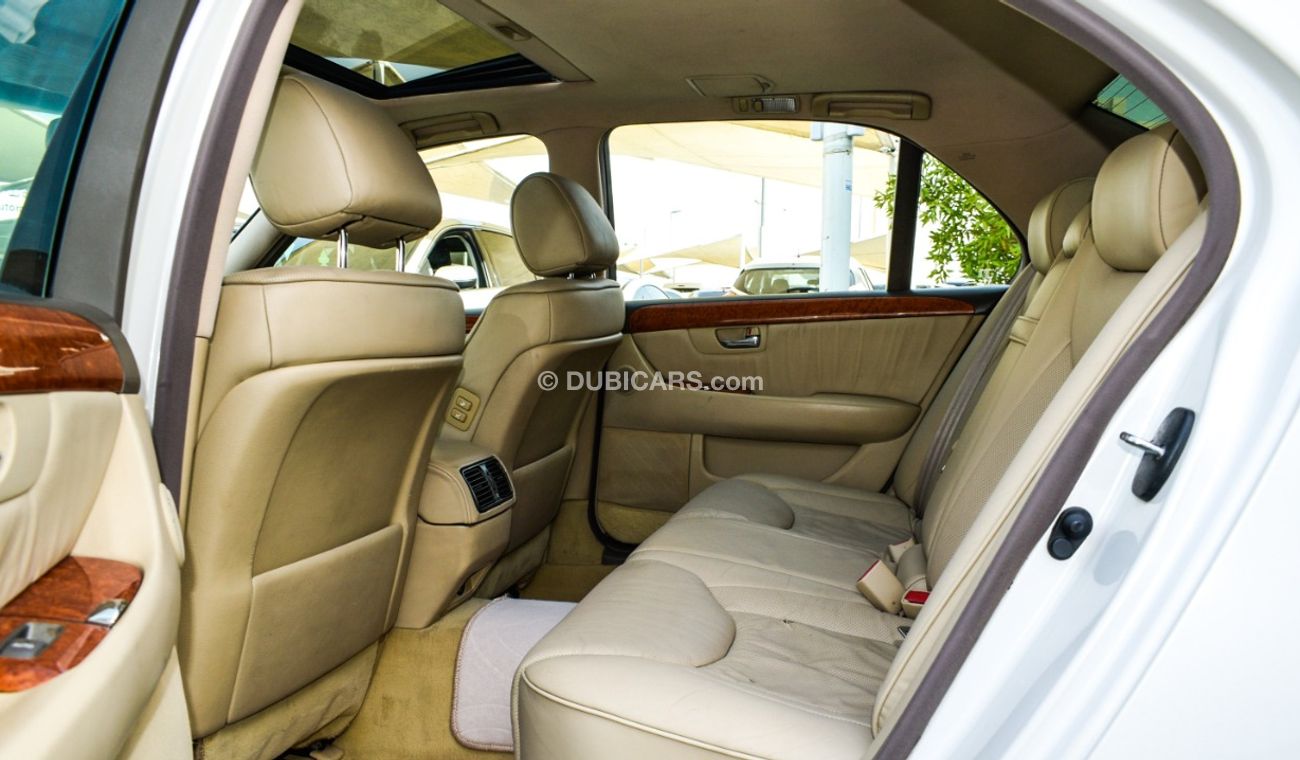 Lexus LS430 Imported 1/2 Ultra 2006 model, white color, leather opening, wooden wheels, electric mirrors, electr