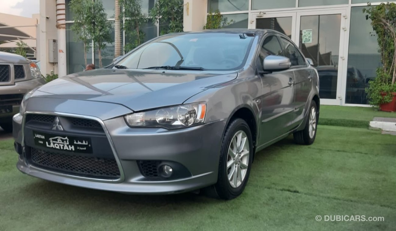 Mitsubishi Lancer Gulf gray color inside beige without accidents Rings rear wing sensors fog lights in excellent condi