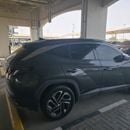 Hyundai Tucson PREMIUM PLUS An olive green car.