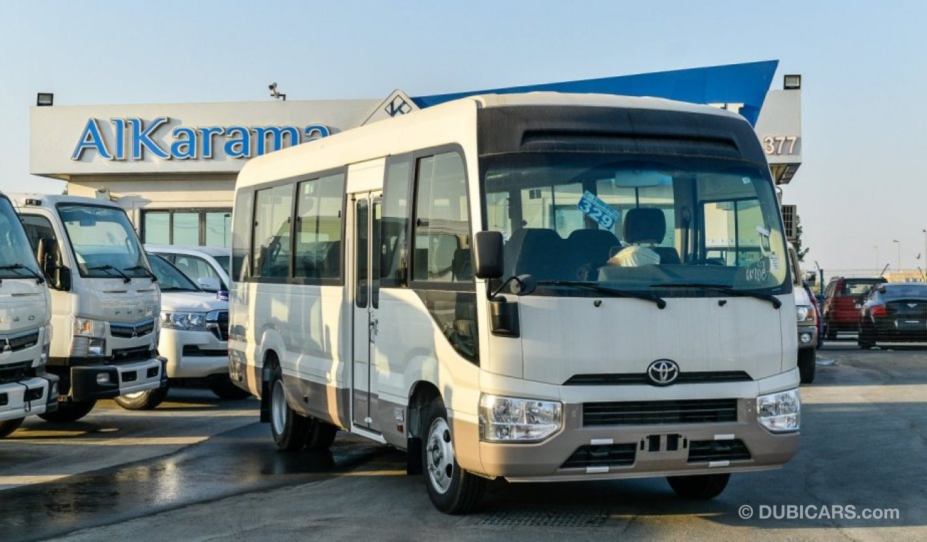 Toyota Coaster 4.2L V6 M/T Diesel 23 passengers - 16″ wheels - brown interior