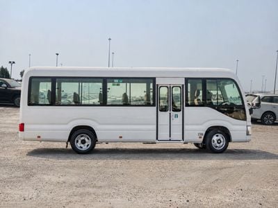 تويوتا كوستر ستاندارد ECTAV0113 - حافلة كوستر 2026 ذات 23 مقعدًا - محرك بنزين 2.7 لتر، ناقل حركة يدوي - لون أبيض