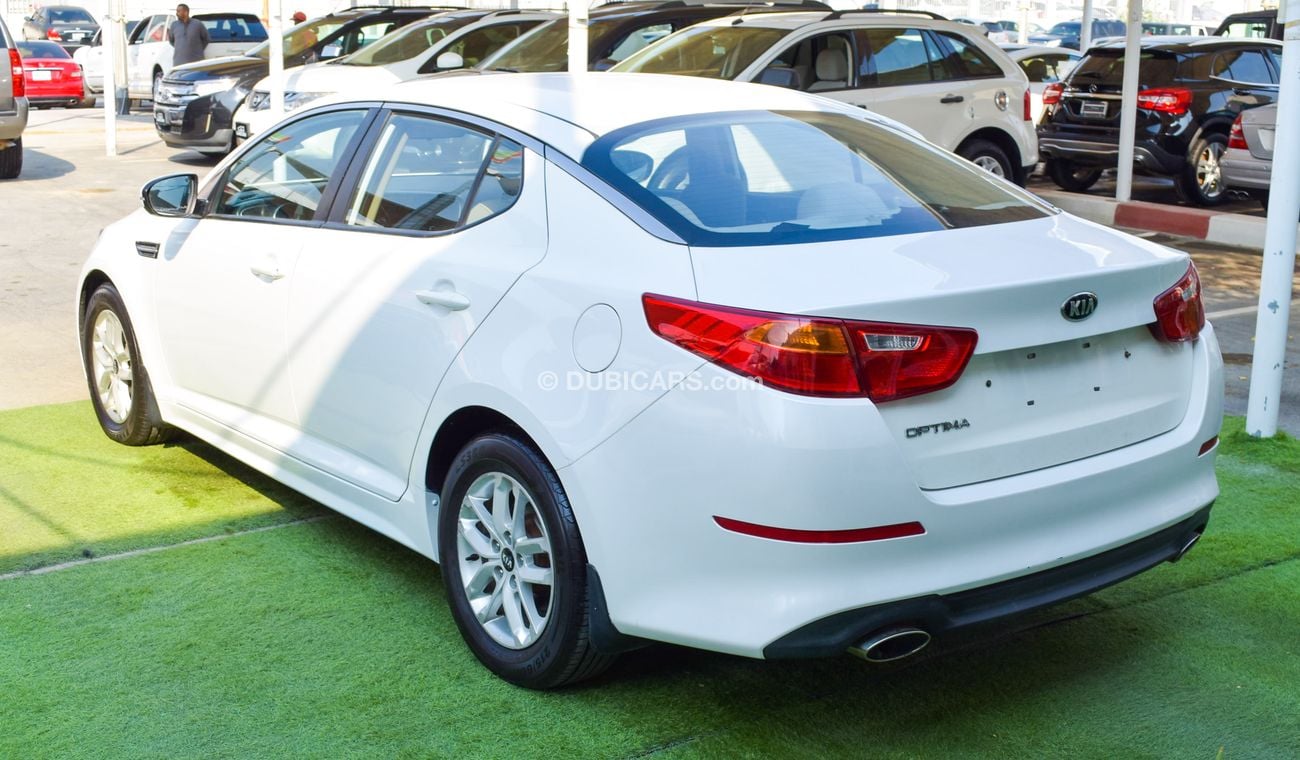 كيا أوبتيما خليجي 2014 لون ابيض داخل بيج رقم 2 رنجات ومثبت سرعه تحكم رنجات حساسات  بحاله ممتازة