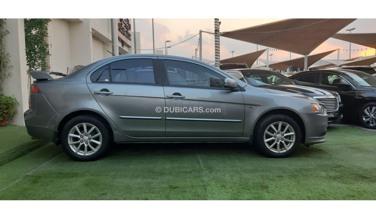 Mitsubishi Lancer Gulf gray color inside beige without accidents Rings rear wing sensors fog lights in excellent condi