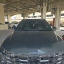 Hyundai Tucson PREMIUM PLUS An olive green car.