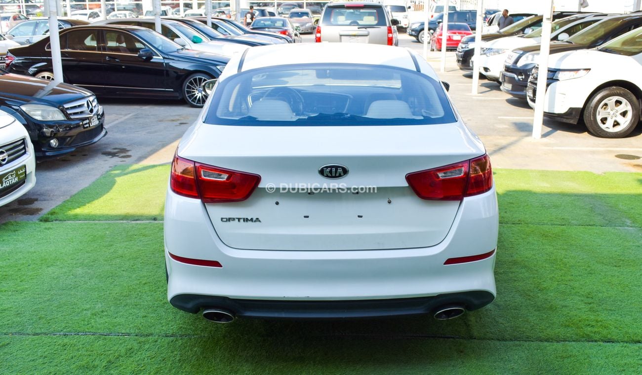 كيا أوبتيما خليجي 2014 لون ابيض داخل بيج رقم 2 رنجات ومثبت سرعه تحكم رنجات حساسات  بحاله ممتازة